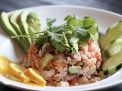 Shrimp Ceviche surrounded by cucumbers, avocado slices, and orange slices.