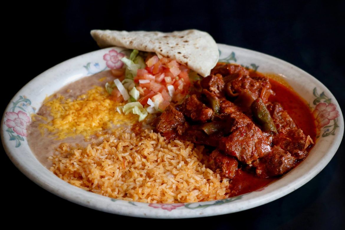 Chile Colorado: Beef simmered until very tender in a red sauce, tomatoes, onions, mild peppers and spices served with rice and beans.