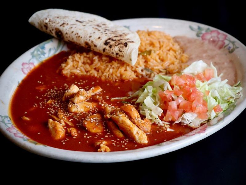 Chicken Mole: Sliced chicken breast specially prepared with fresh mushrooms, onion and green pepper served on a bed of rice with Jack cheese, smothered with our special mild sauce, garnished with avocado and tomatoes.